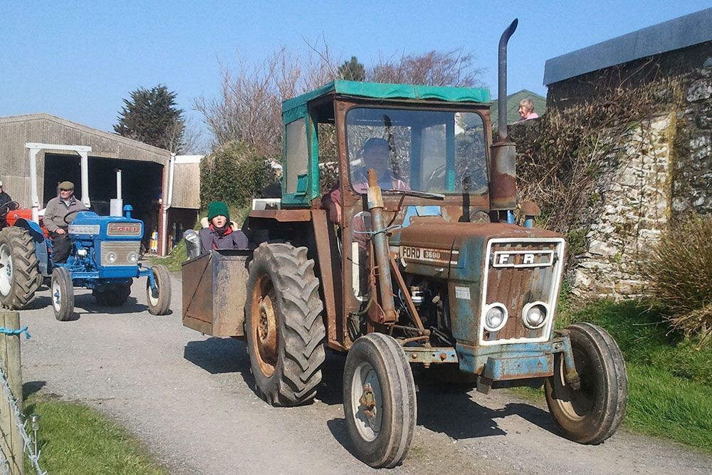 A ford tractor is parked on the side of the road