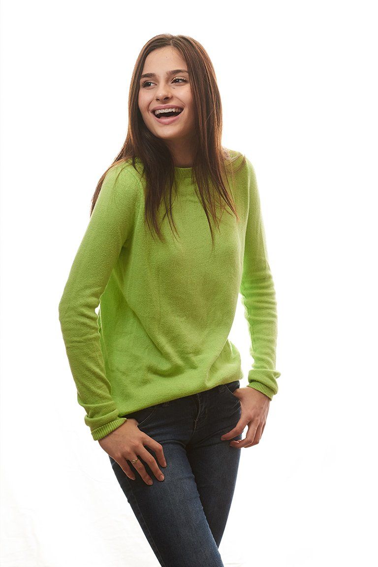Girl wearing green top with beautiful teeth — Buffalo Grove, IL — Rosen Orthodontics