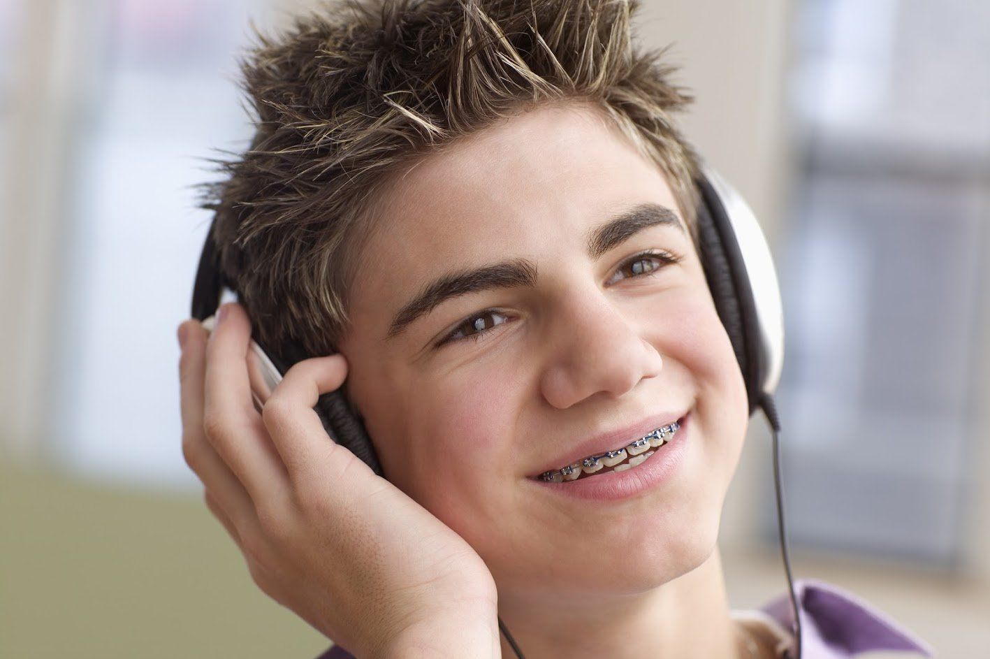 Boy wearing braces listening to music — Buffalo Grove, IL — Rosen Orthodontics