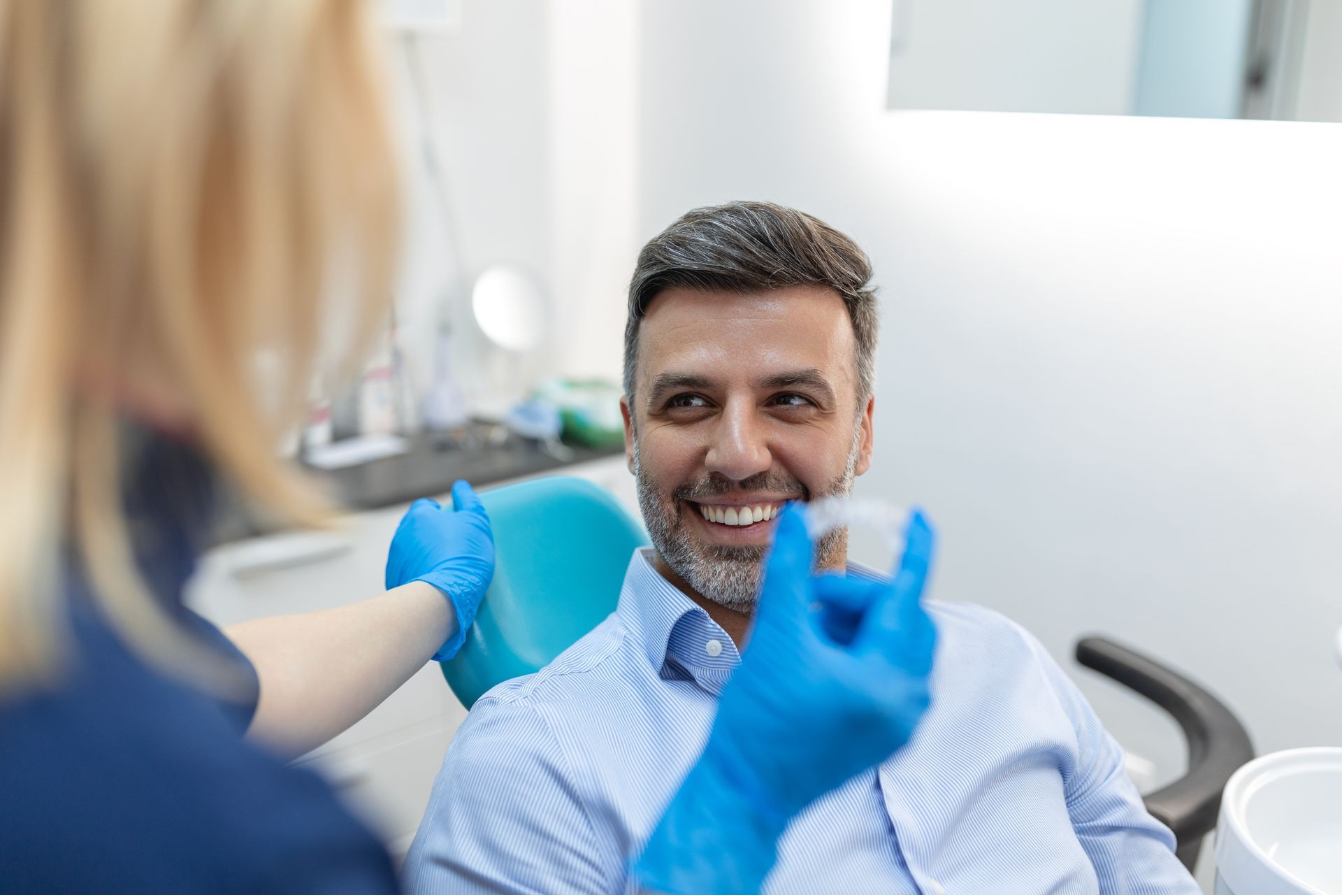 A dentist is holding the Invisalign of a patient.