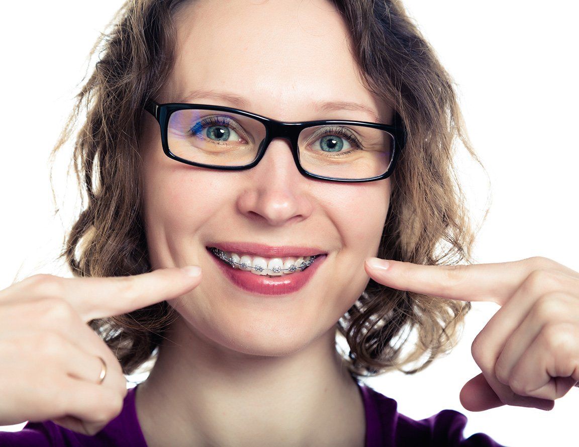 Woman with curly hair and braces — Buffalo Grove, IL — Rosen Orthodontics