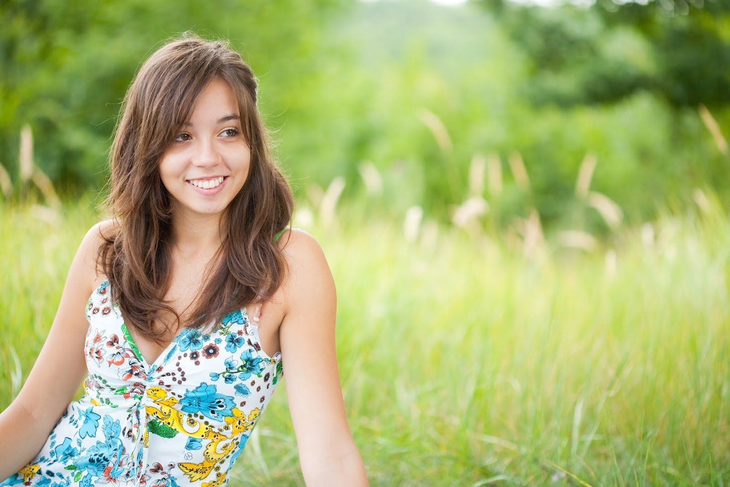Woman sitting on the grass — Buffalo Grove, IL — Rosen Orthodontics