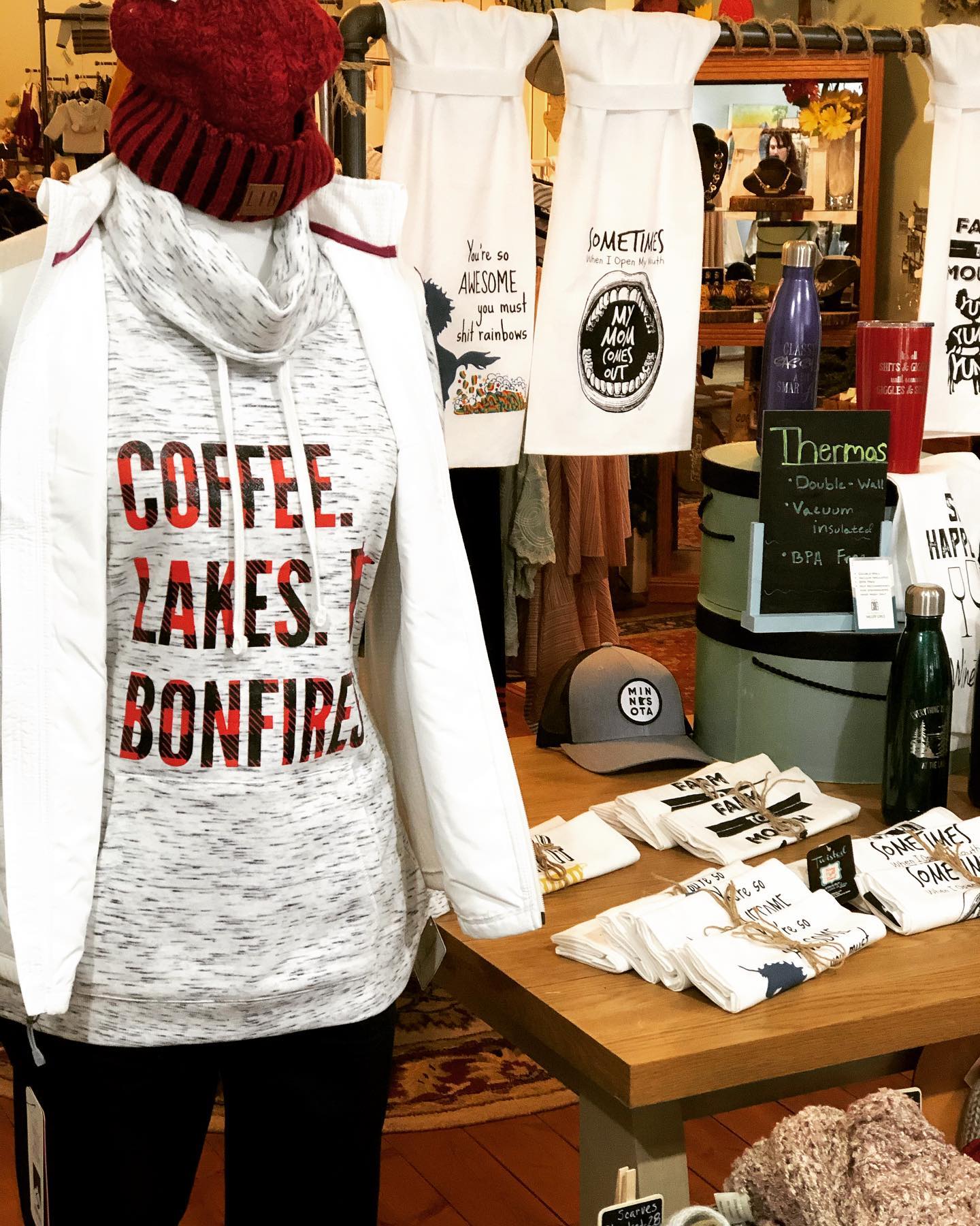 A mannequin wearing a hoodie that says coffee lakes bonfire
