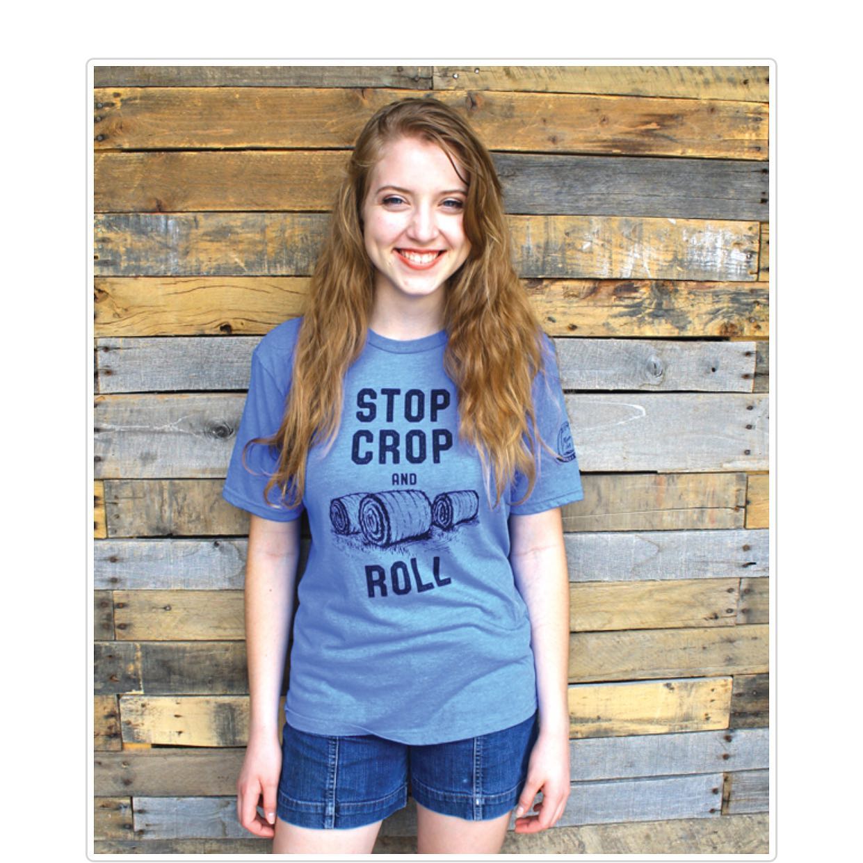 A girl wearing a blue shirt that says stop crop roll