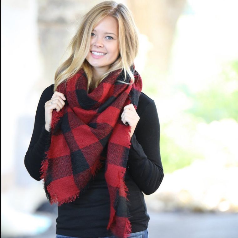 A woman wearing a black shirt and a red and black scarf