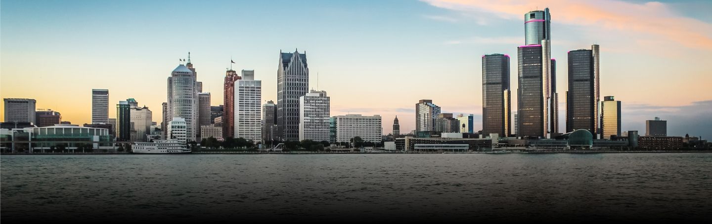 A city skyline with a body of water in the foreground. | Ode Auto Repair & Tire