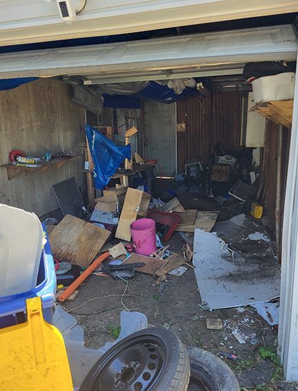 A garage filled with lots of junk and tires.