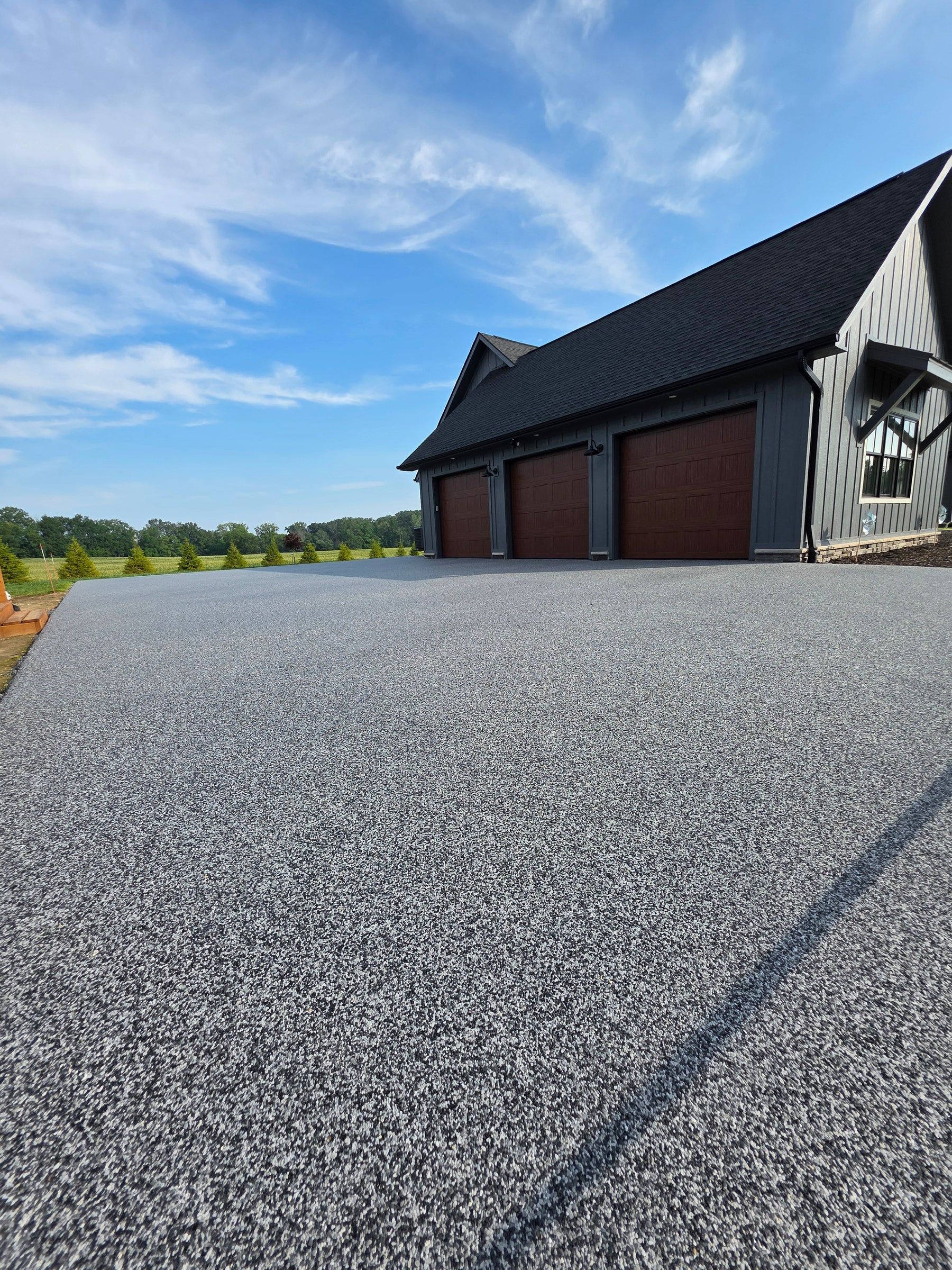 Elite Outdoor Living Solutions is installing a custom swimming pool with a waterfall in Oklahoma City.