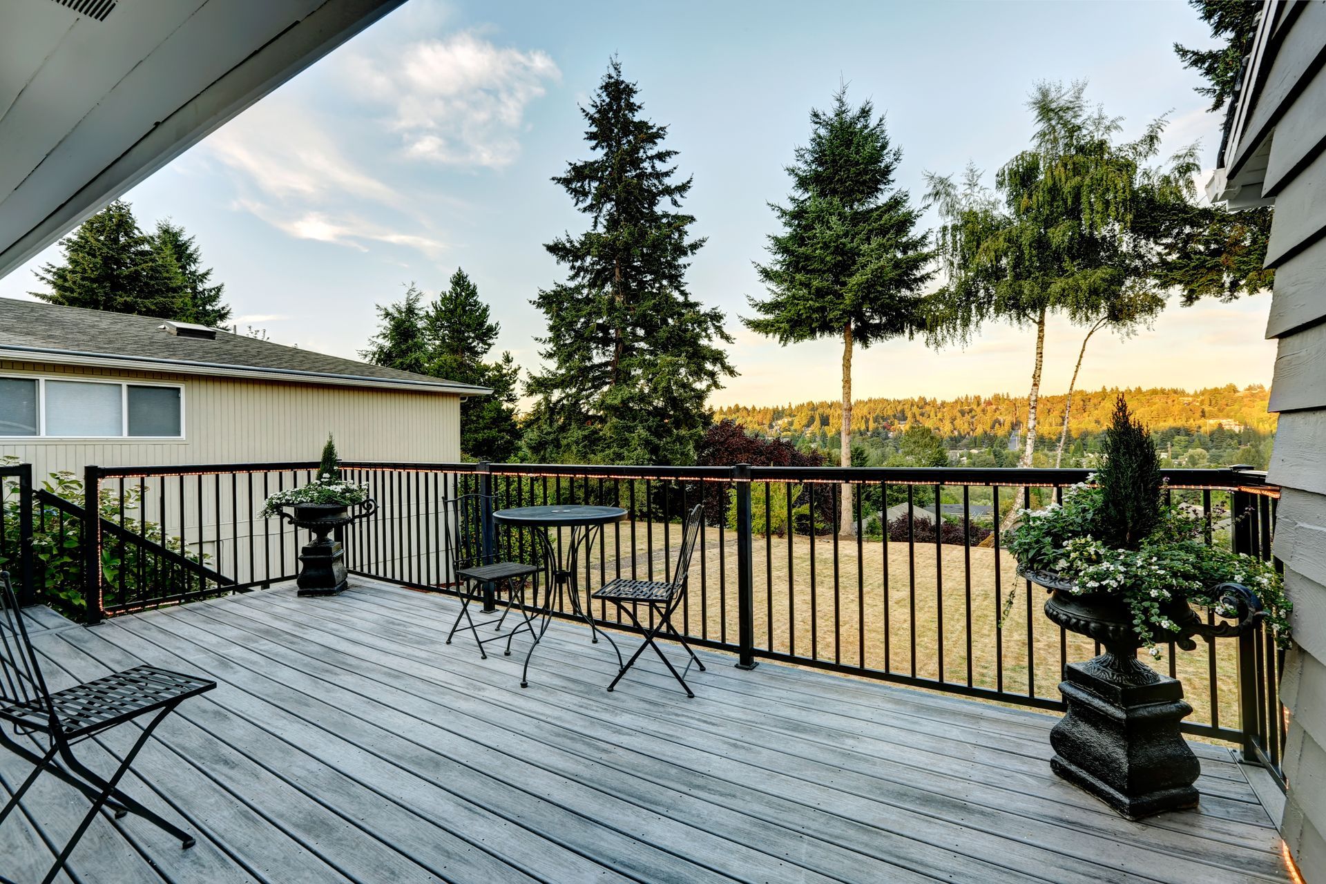 A wooden deck with a table and chairs on it