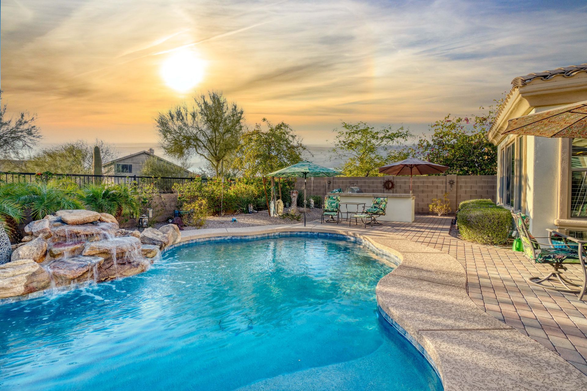 Elite Outdoor Living Solutions is installing a custom swimming pool with a waterfall in Oklahoma City.