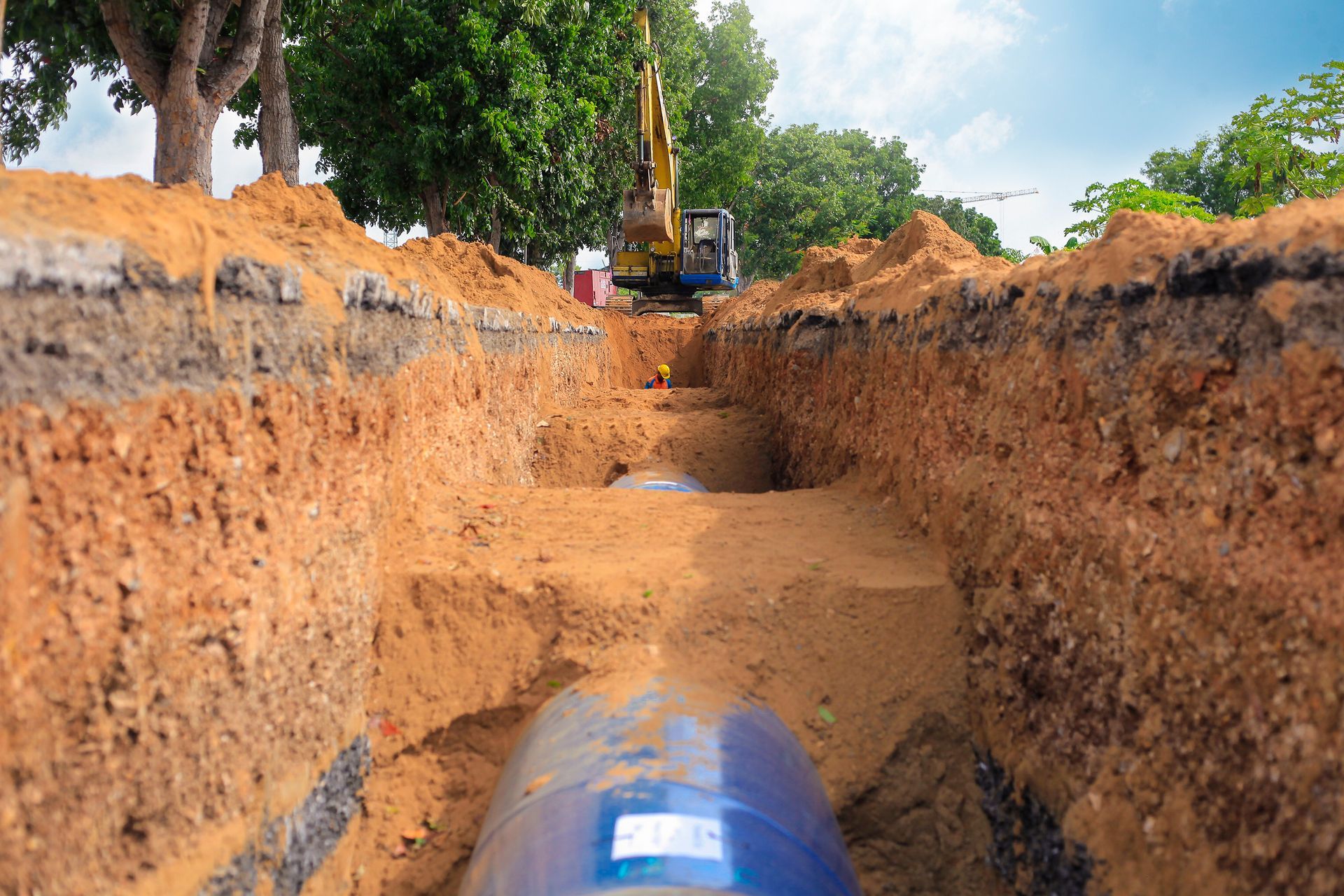 Elite Outdoor Living Solutions preparing ground for French drain installation in Nichols Hills, OKC.