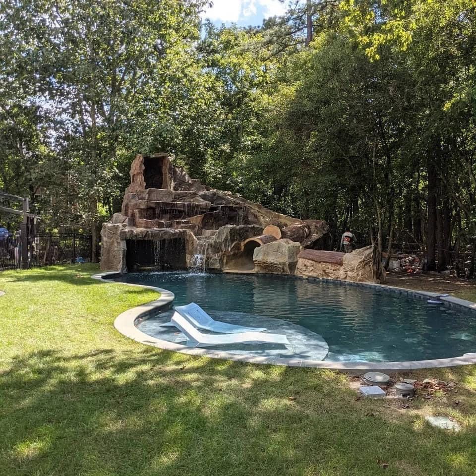 Elite Outdoor Living Solutions is installing a custom swimming pool with a waterfall in Oklahoma City.