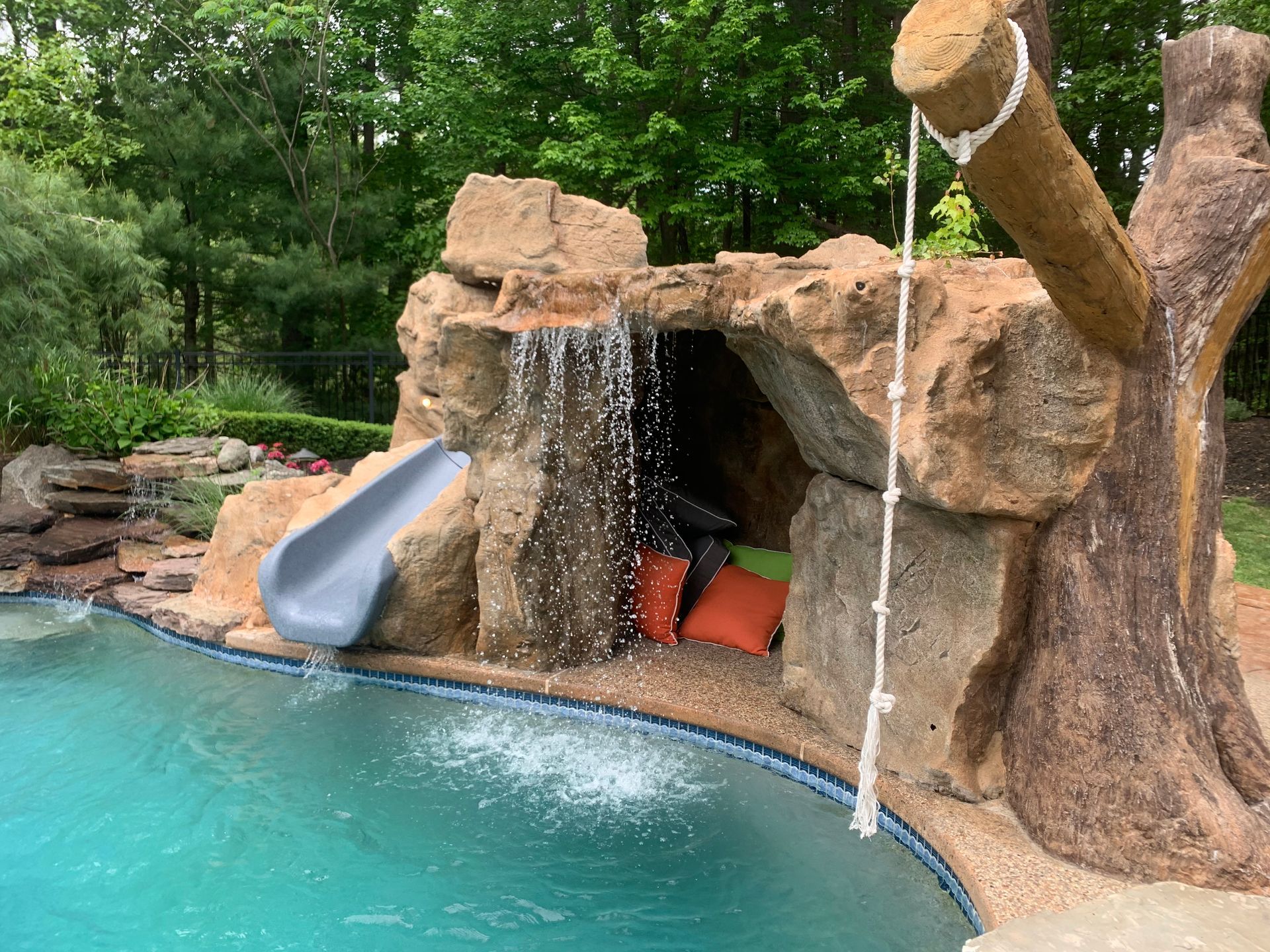 Elite Outdoor Living Solutions is installing a custom swimming pool with a waterfall in Oklahoma City.