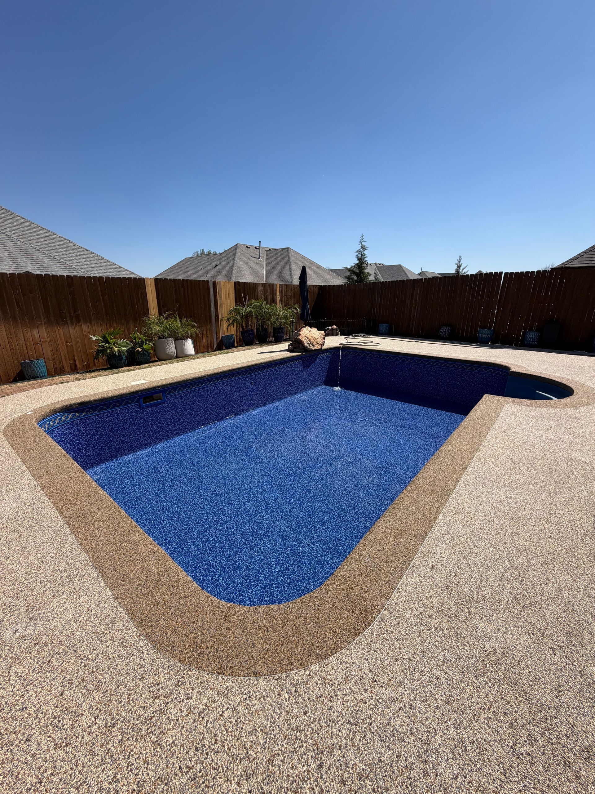 Elite Outdoor Living Solutions is designing a custom pool for a residential backyard in Oklahoma City.