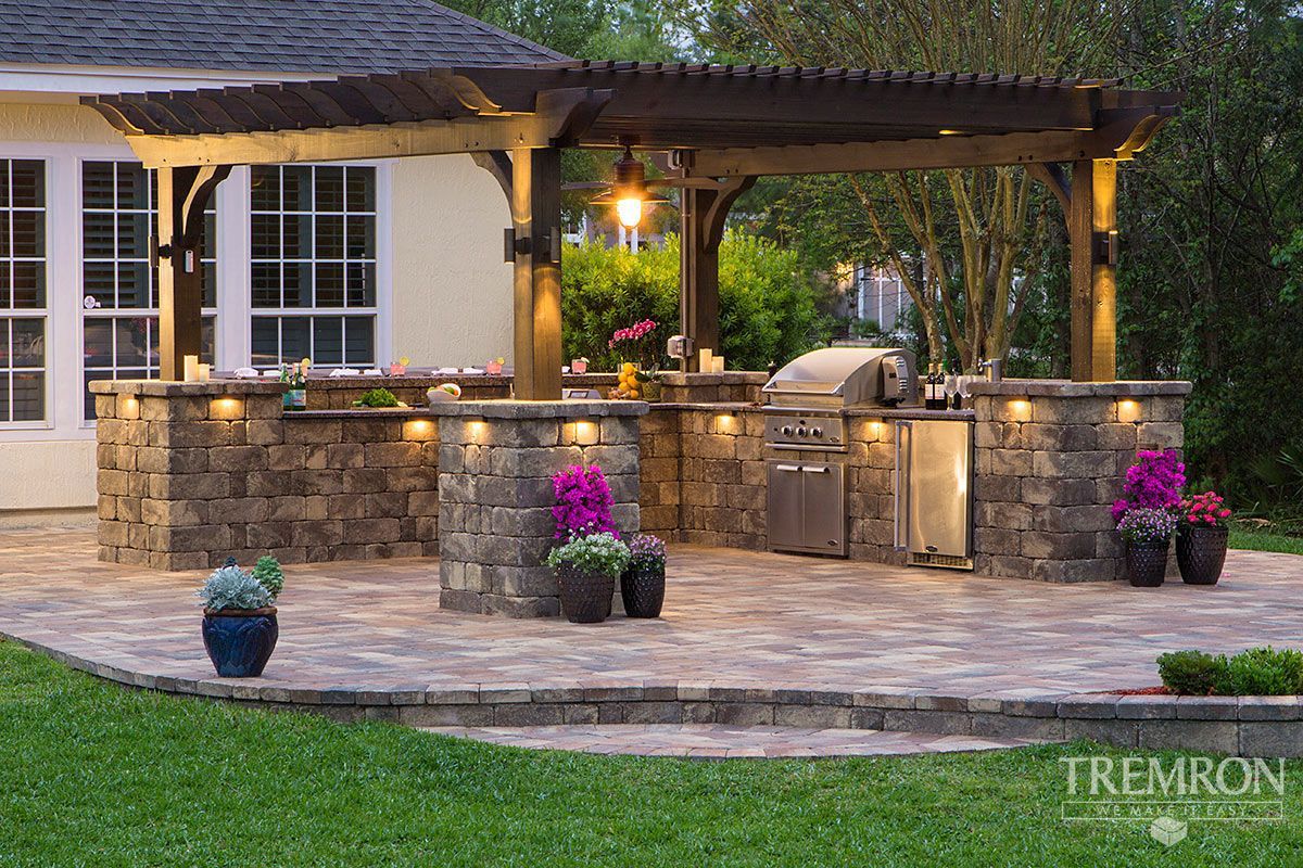 Elite Outdoor Living Solutions built an outdoor patio with pergola, grill, and flowers in Piedmont, OK.