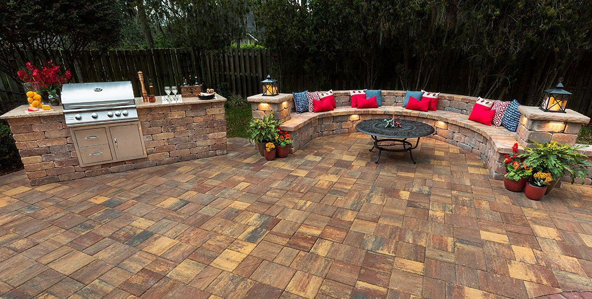 Elite Outdoor Living Solutions designed a brick patio with a grill and seating in Crown Heights, OKC.