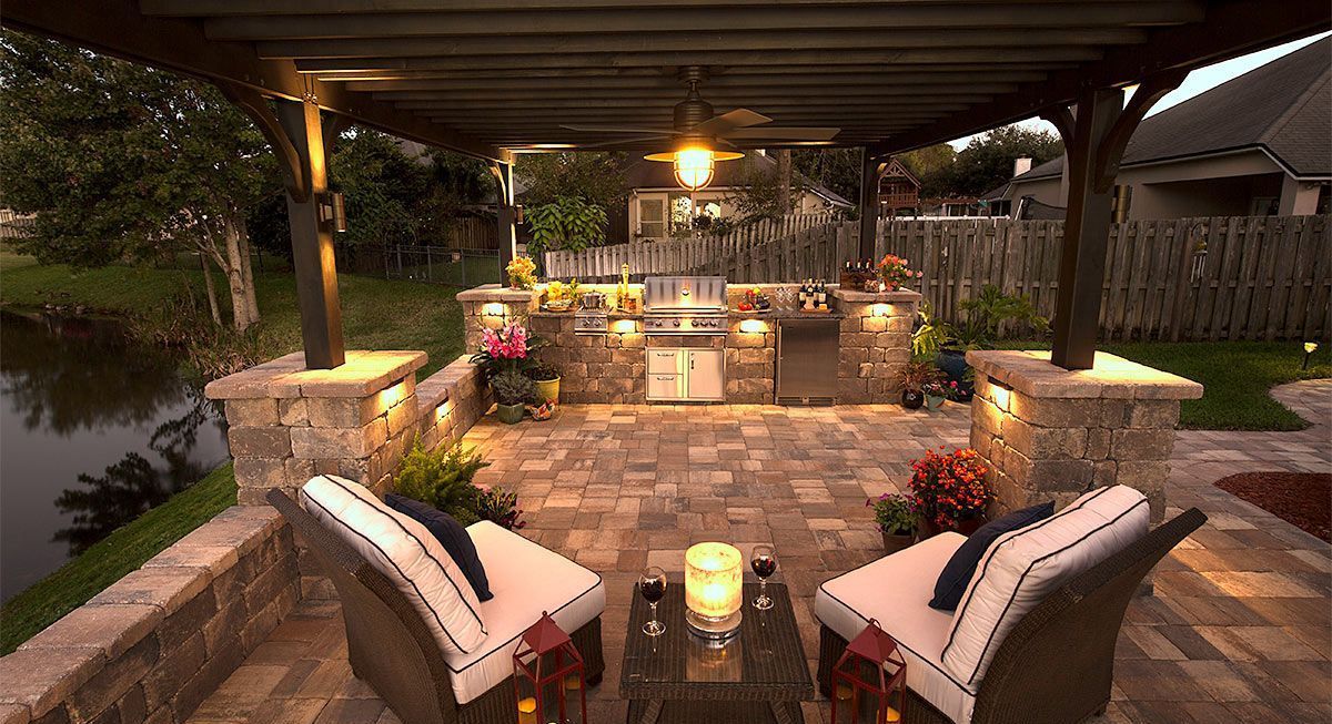 Elite Outdoor Living Solutions created an outdoor dining area with pergola lighting in Heritage Hills, OKC.