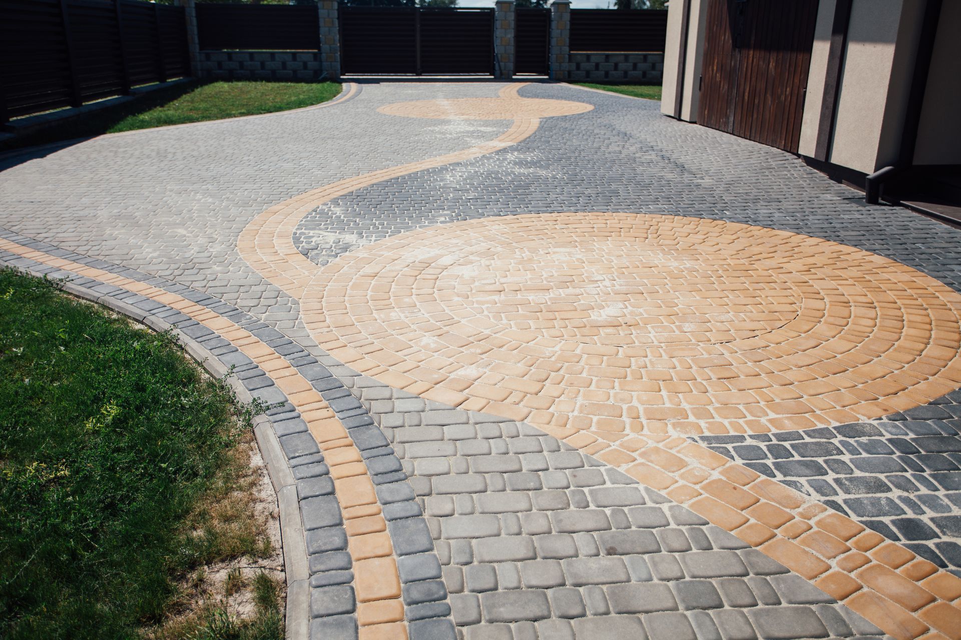 Elite Outdoor Living Solutions is installing a brick paver driveway with a circular pattern in Yukon, OK.