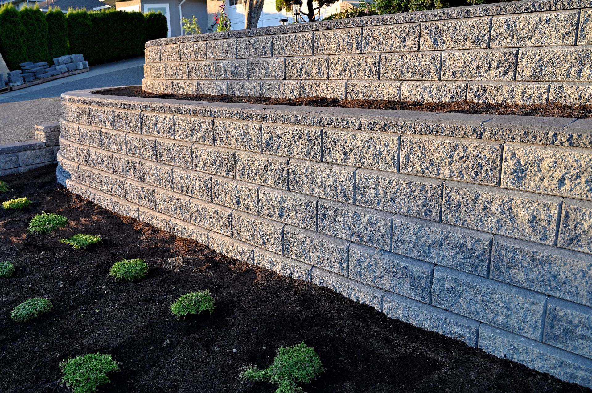 Elite Outdoor Living Solutions is installing a retaining wall to prevent soil erosion in Gaillardia, OKC.