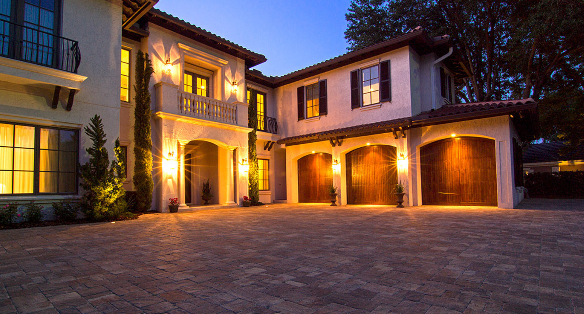 Elite Outdoor Living Solutions completed a beautifully illuminated driveway leading to a large home in Oklahoma City.