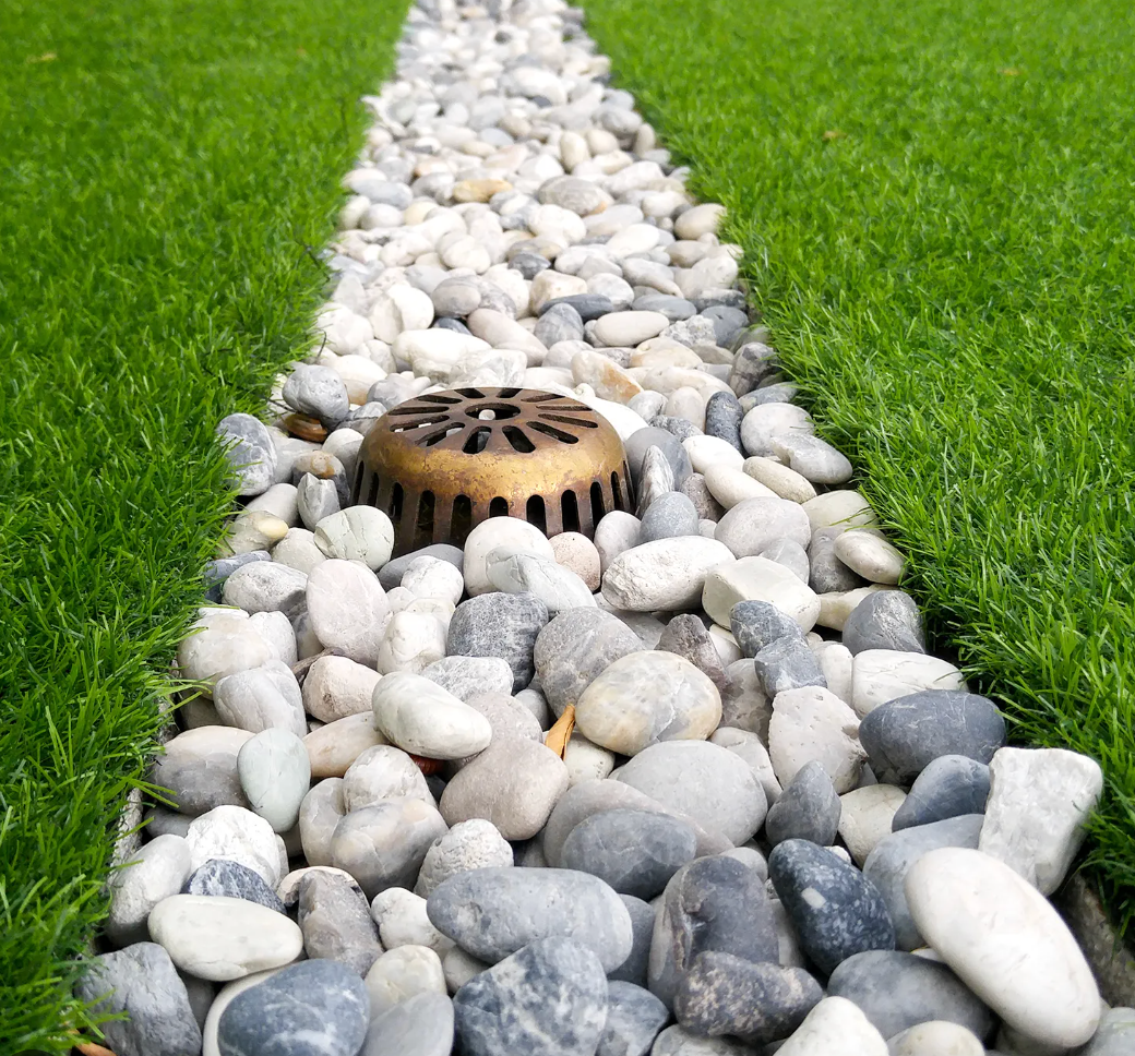 Elite Outdoor Living Solutions is installing a gorgeous rock drainage path in a garden in Oklahoma City.