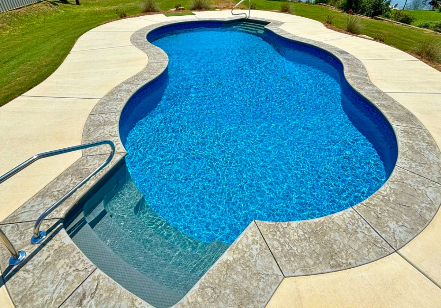 Inground concrete pool with stamped deck in Oklahoma