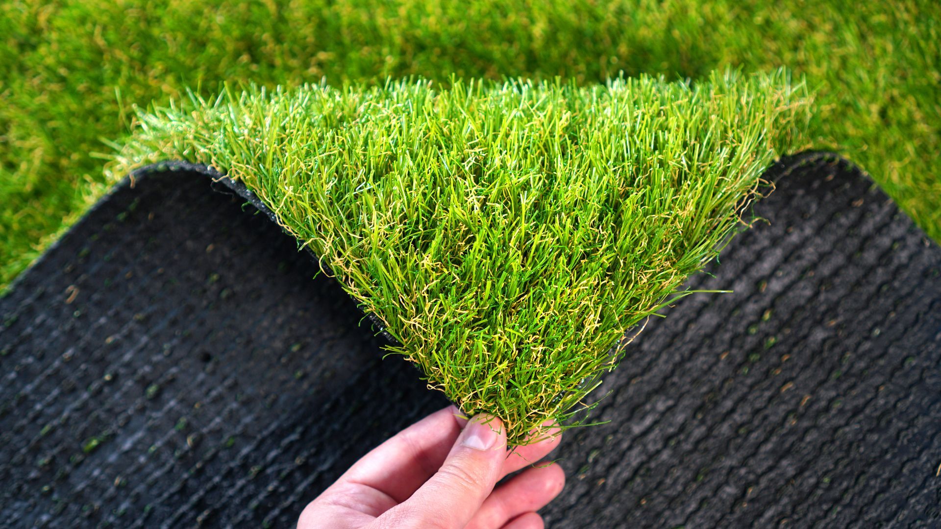 Outdoor Living Solutions is installing artificial turf, displaying its texture and durability in Oklahoma City.