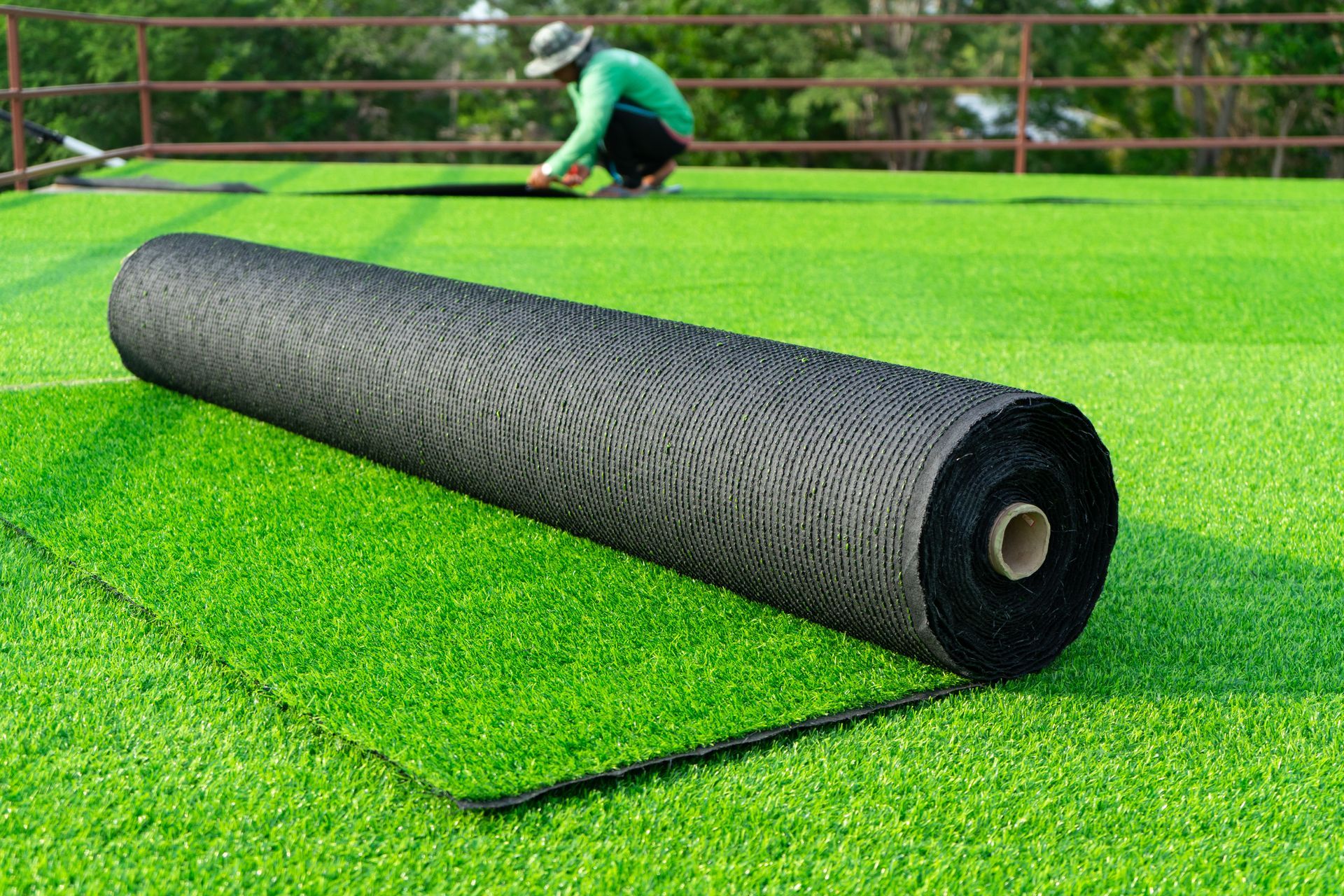 Elite Outdoor Living Solutions is installing a large roll of lbright green artificial turf in Oklahoma City.