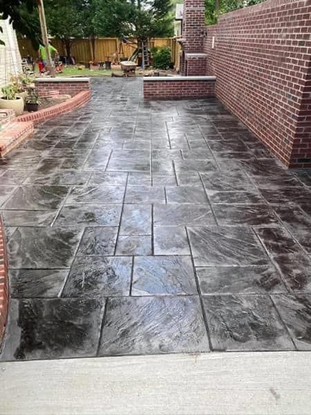 Elite Outdoor Living Solutions is installing a grey colored stamped concrete driveway in Oklahoma City.