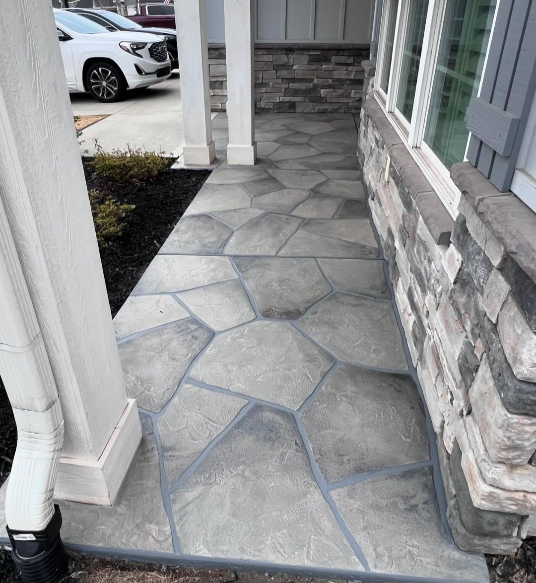 A stunning stone walkway leading to a house installed by Elite Outdoor Living Solutions in Nichols Hills, OKC.