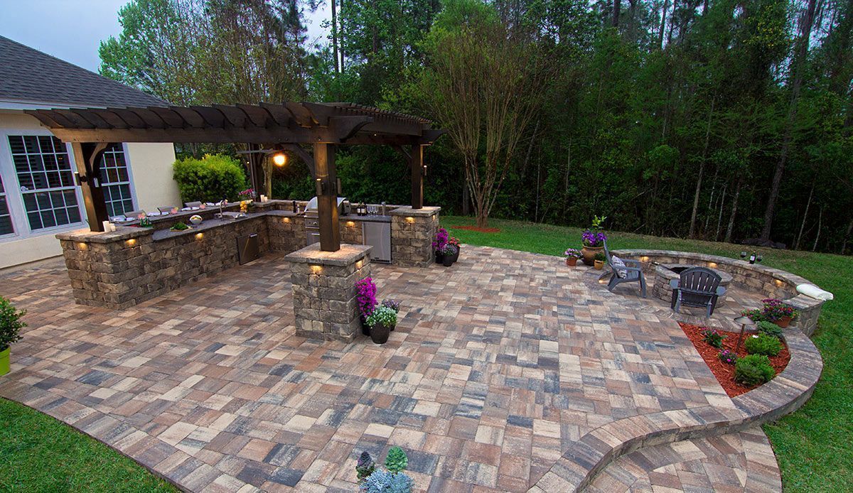 Elite Outdoor Living Solutions installed a large patio with an outdoor kitchen and fire pit in Belle Isle, OKC.