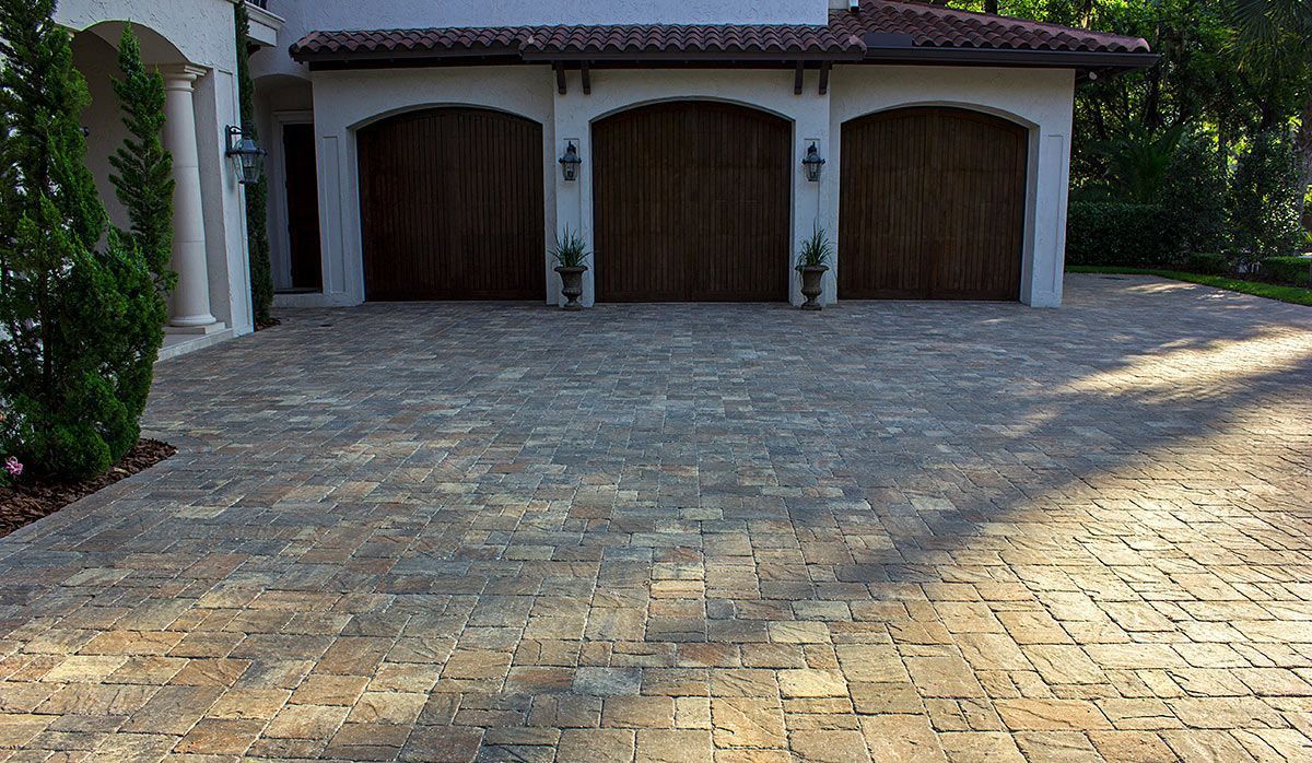 Elite Outdoor Living Solutions installed a brick paver driveway in front of a residential garage in Yukon, OK.