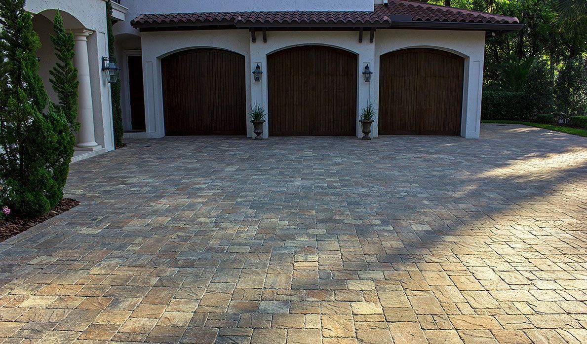 Elite Outdoor Living Solutions created a brick paver driveway leading to a residential house in Yukon, OK.