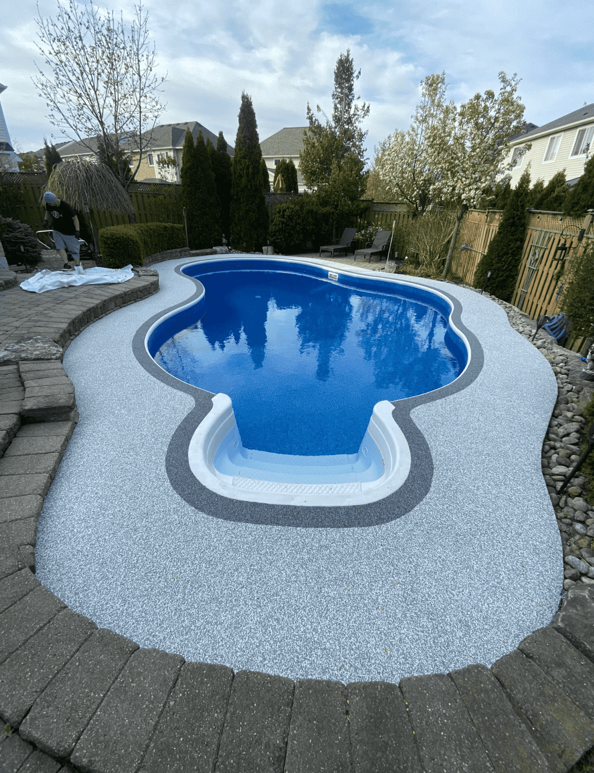 Elite Outdoor Living Solutions is installing a custom swimming pool with a waterfall in Oklahoma City.