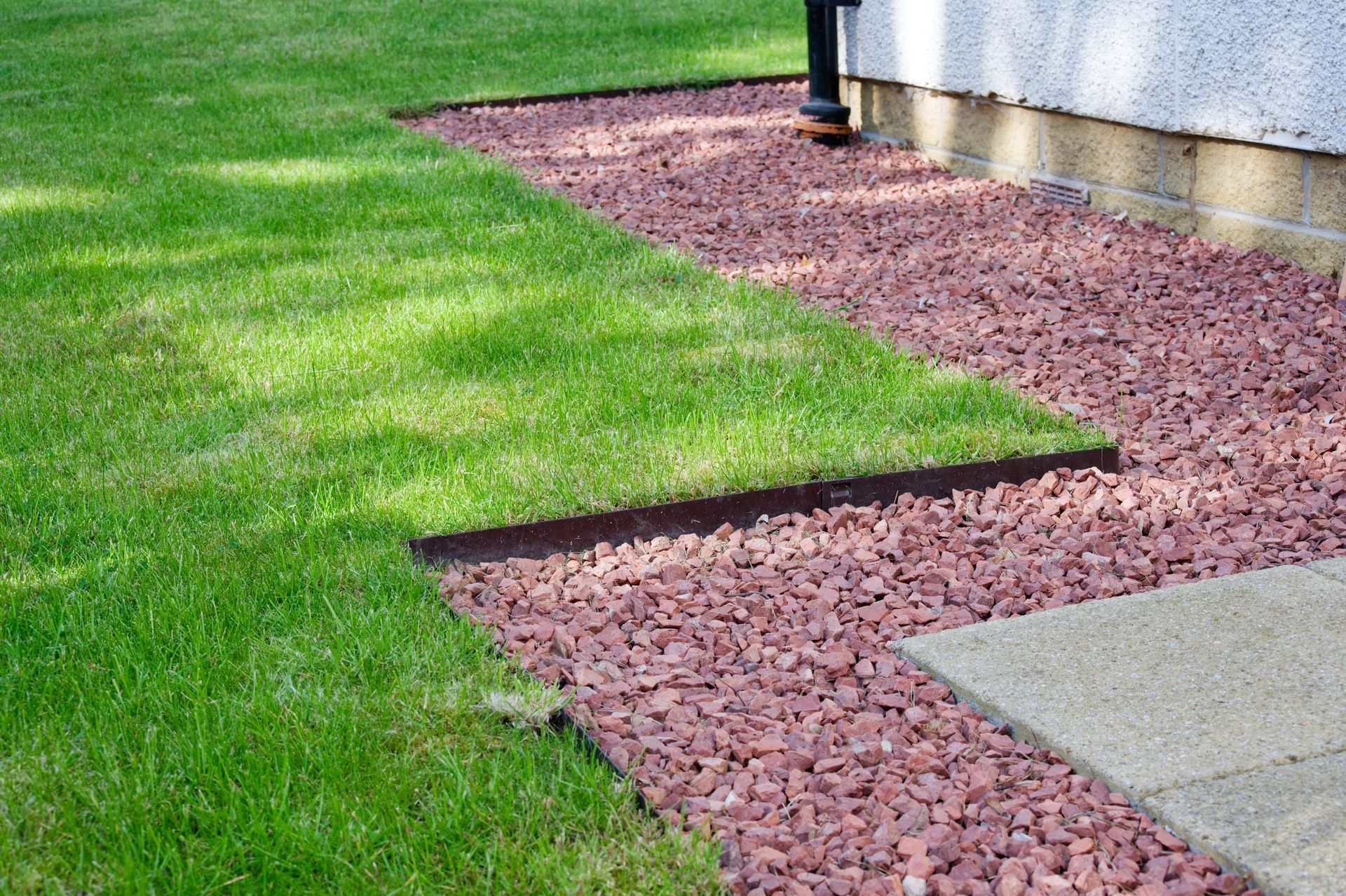 Elite Outdoor Living Solutions completed grading and installed a paver walkway beside grass landscaping in Moore, OK.