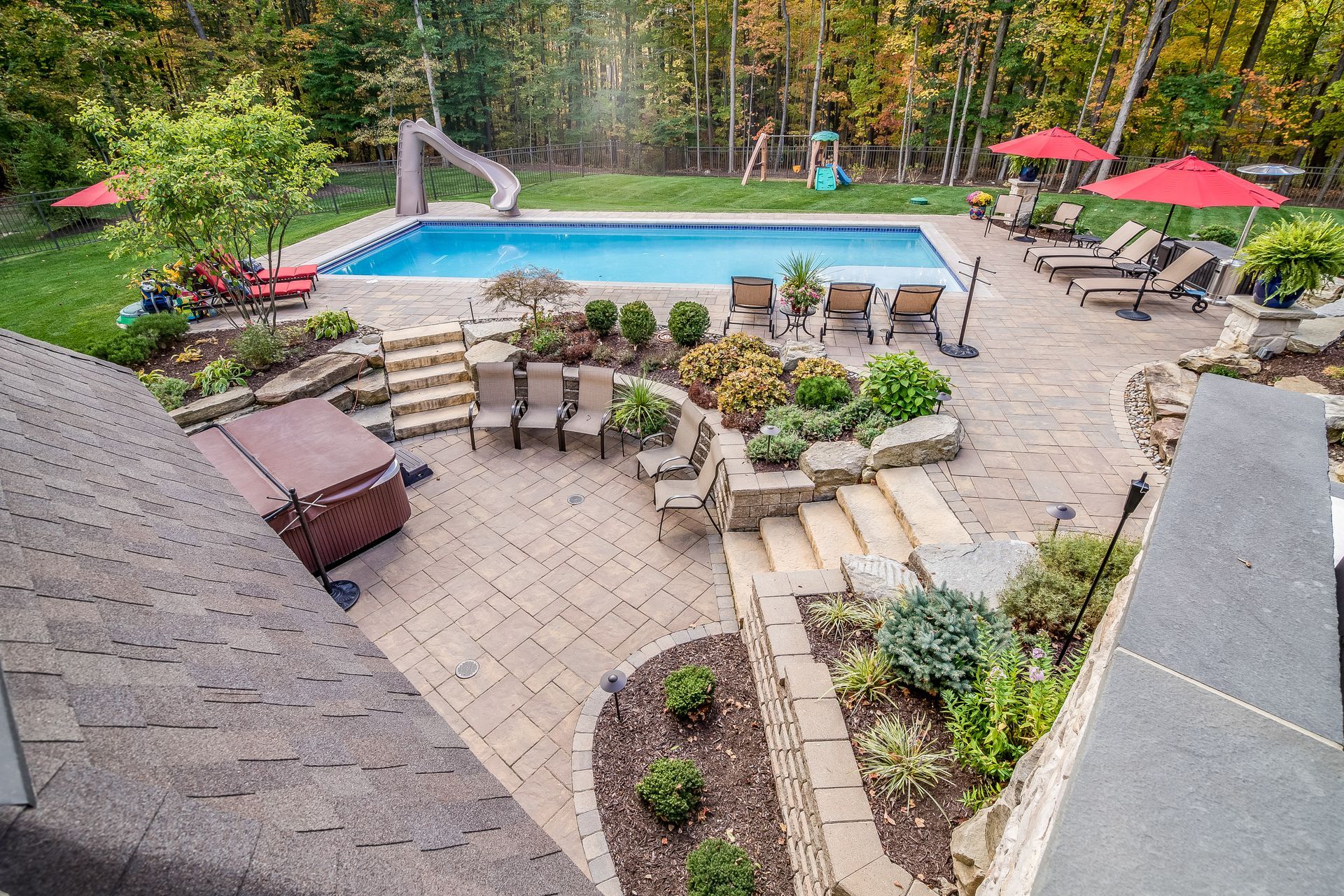 Elite Outdoor Living Solutions installed a spacious paver patio surrounding a swimming pool in Heritage Hills, OKC.