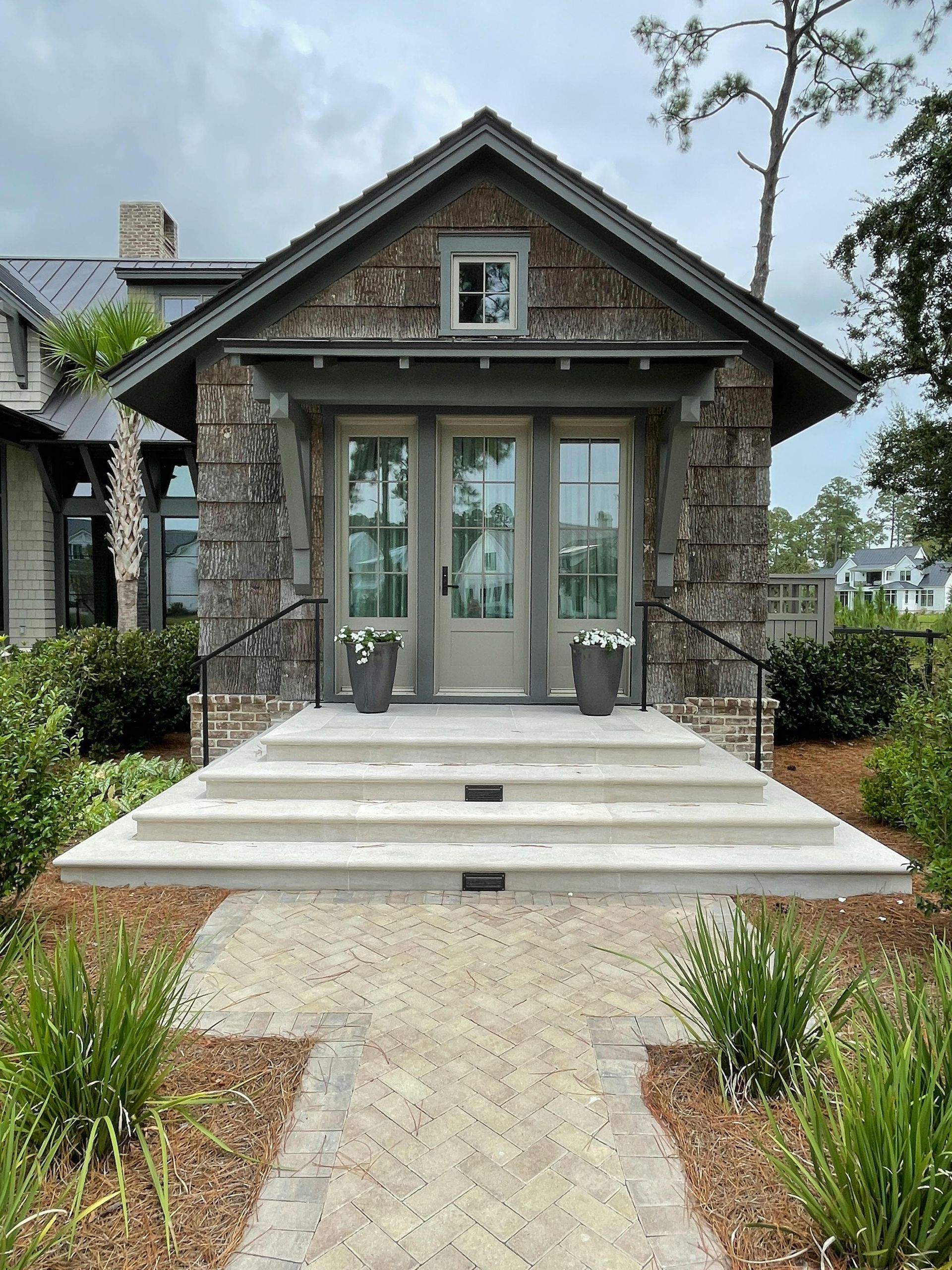 Elite Outdoor Living Solutions installed concrete steps and a walkway leading to the front door of a home in Oklahoma City.