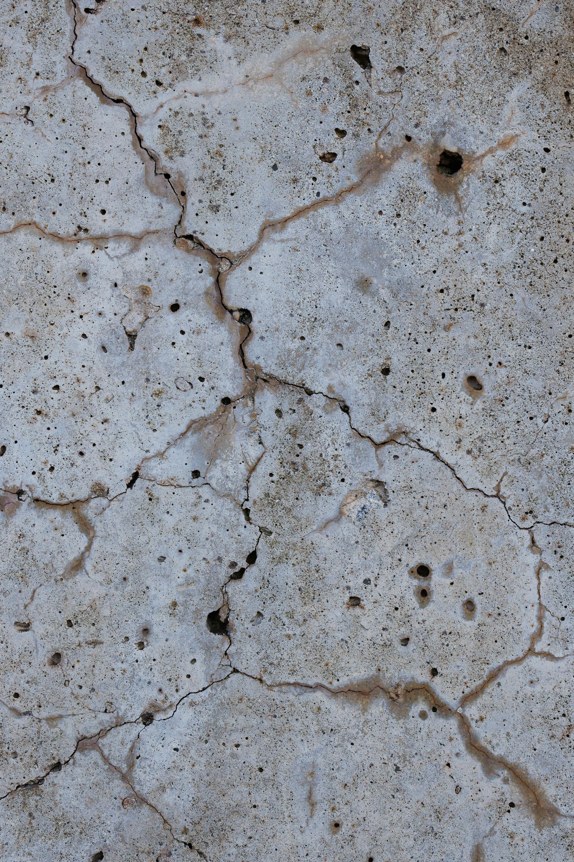 A close up of a cracked concrete surface to be fized by Elite Outdoor Living Solutions in Oklahoma City.