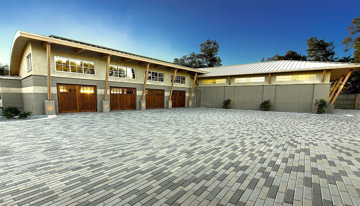 Elite Outdoor Living Solutions installed a large paved driveway area in front of spacious garages in Oklahoma City.