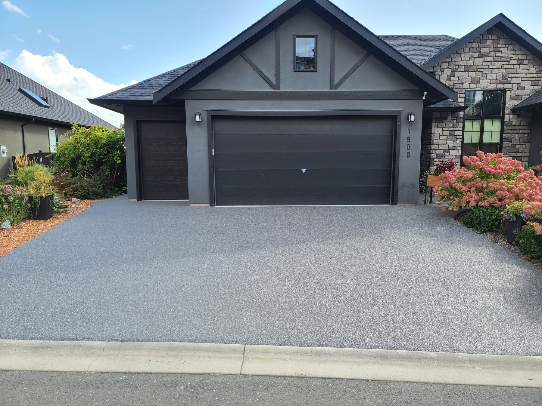Elite Outdoor Living Solutions installed a custom stone fire pit with surrounding patio seating in Heritage Hills, OKC.