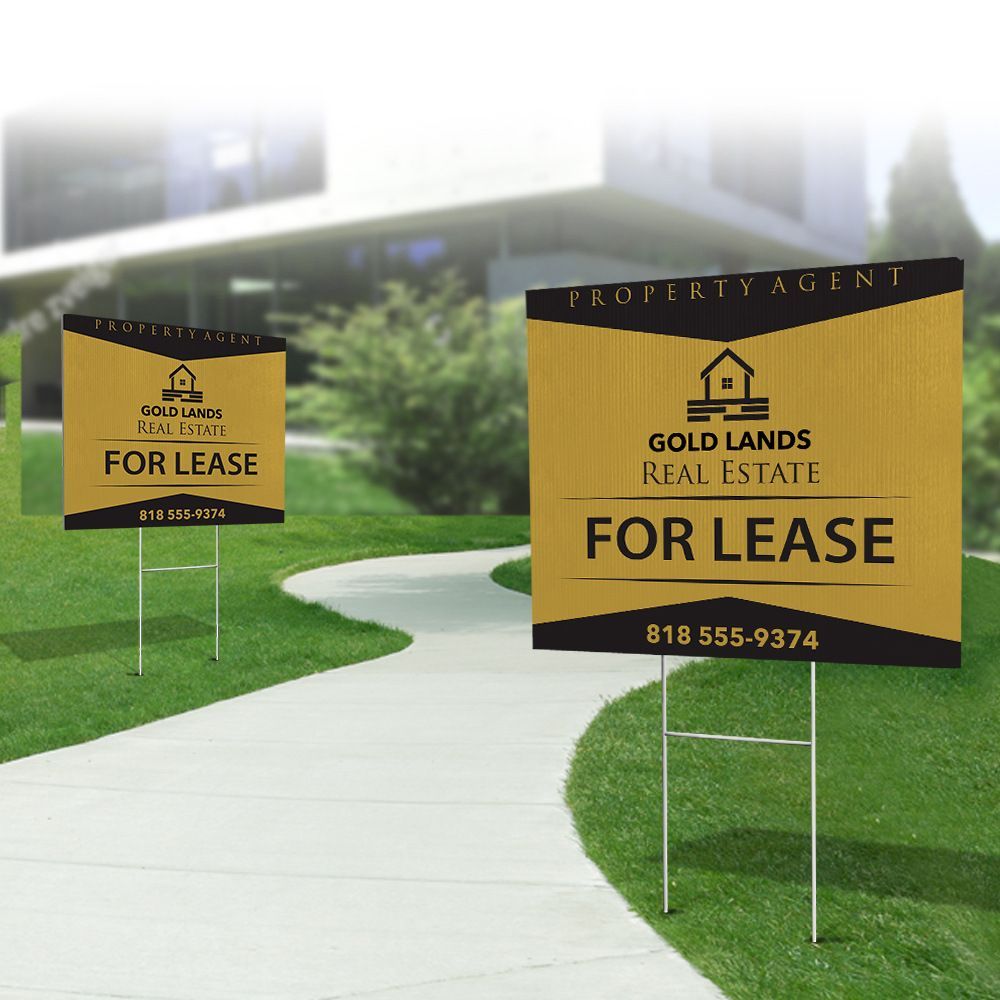 Two for lease signs on a sidewalk in front of a house