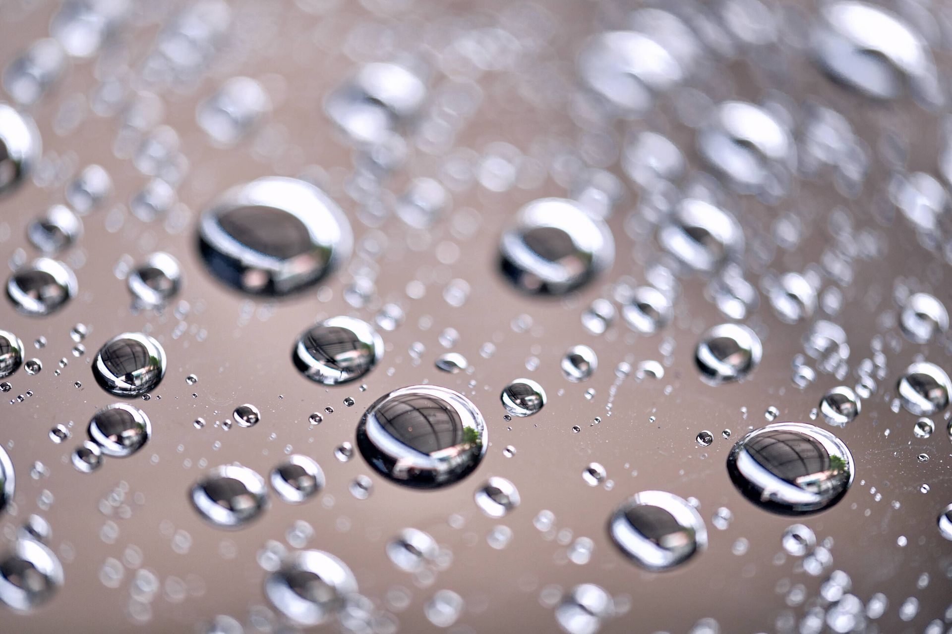 A close up of water drops on a glass surface