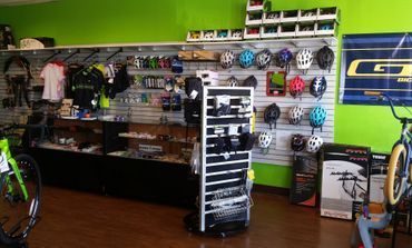 A bicycle shop filled with lots of bicycles and helmets.