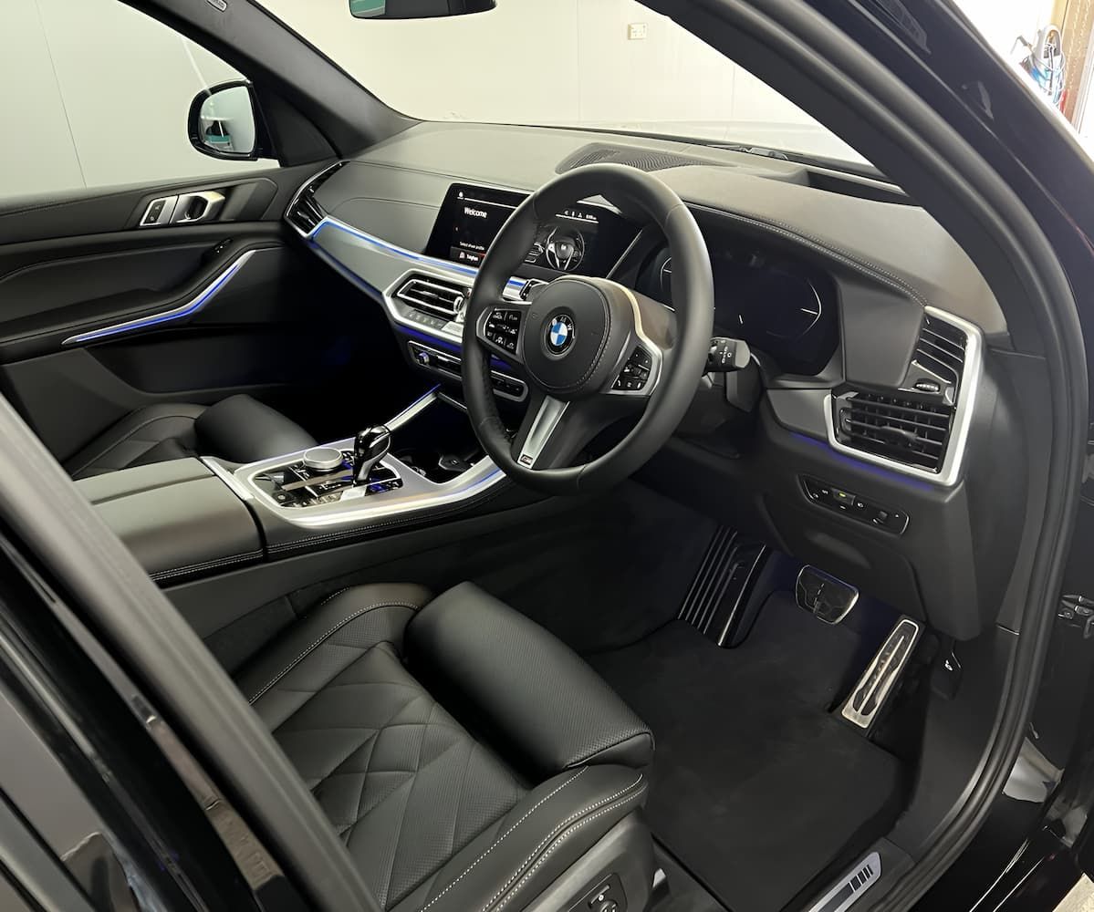 The Interior of a Black BMW X5 With the Door Open — Straightline Detailing Cairns in Bungalow, QLD