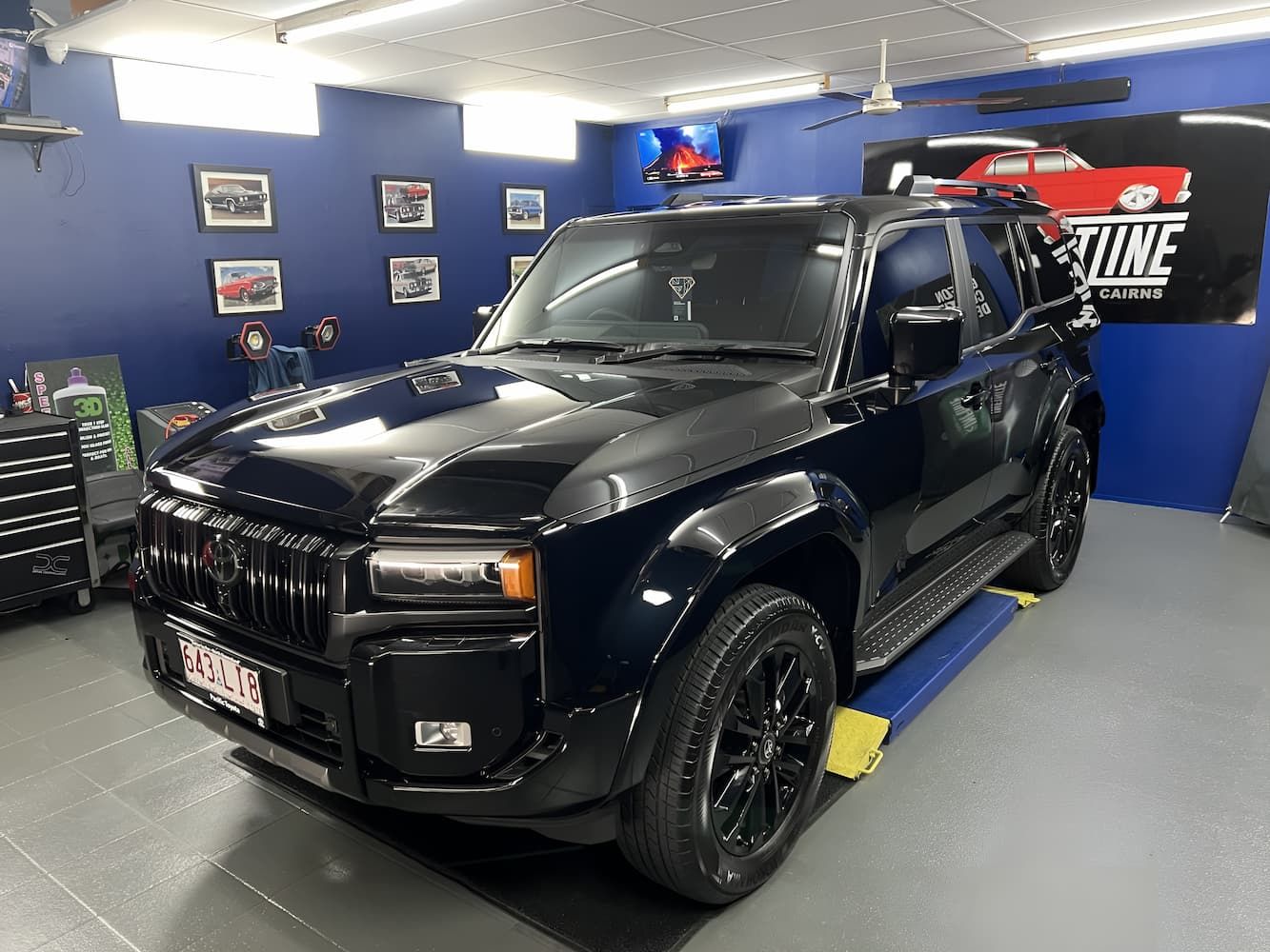 Black SUV In a Blue Auto Shop — Straightline Detailing Cairns in Bungalow, QLD