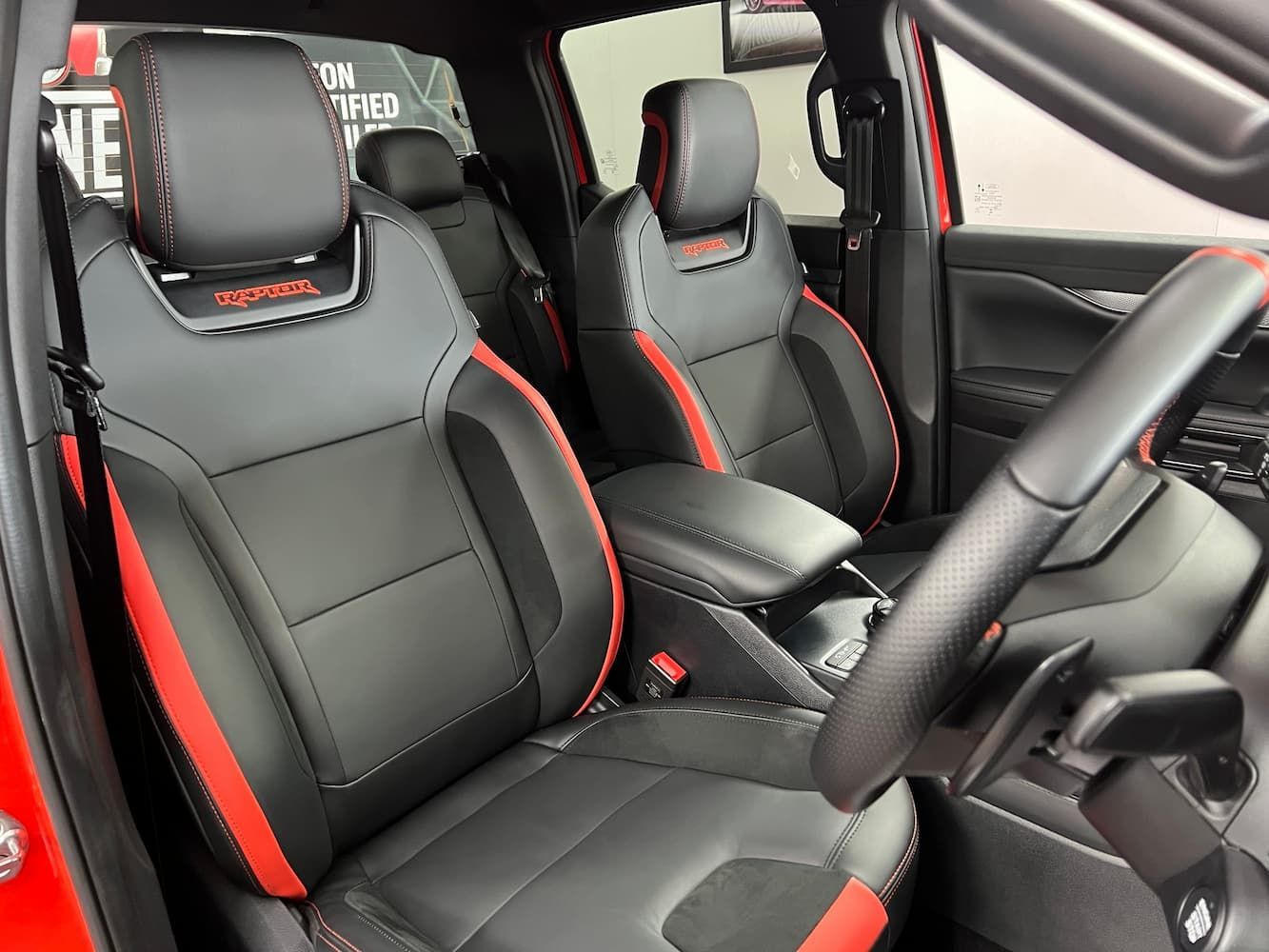 The Interior of a Red Car With Black and Red Seats and a Steering Wheel — Straightline Detailing Cairns in Bungalow, QLD