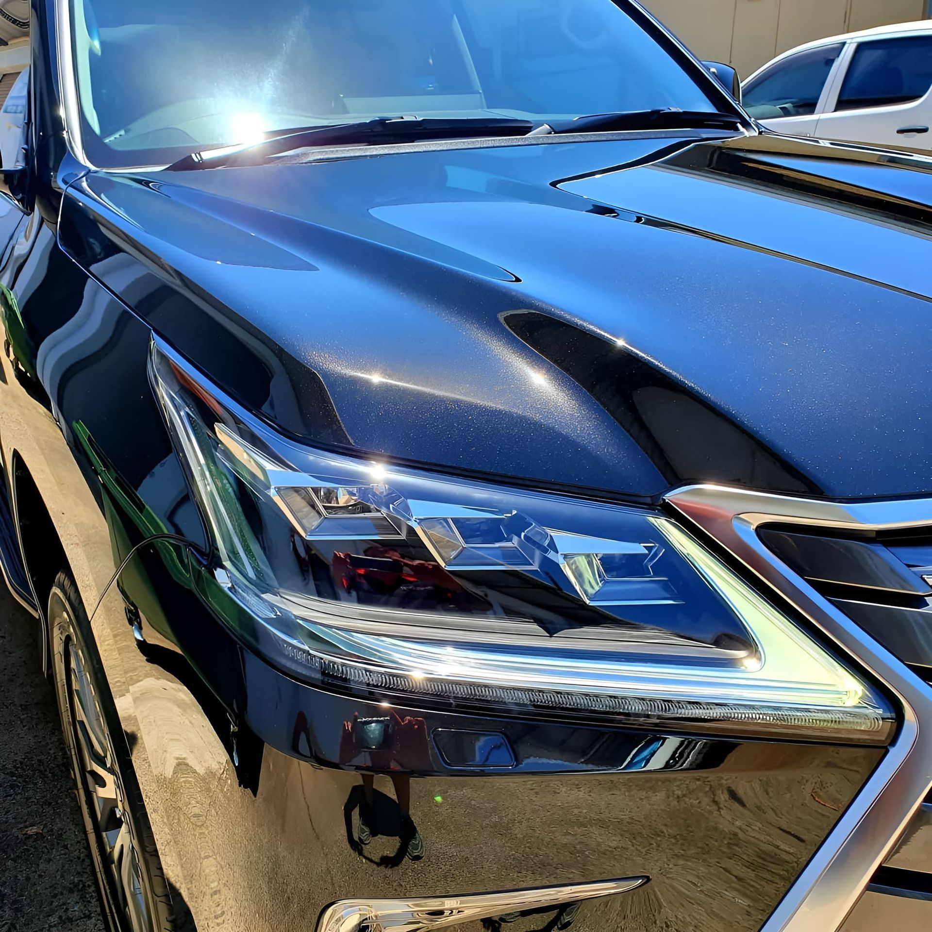 Close-Up of A Shiny Black Lexus SUV Front Headlight — Straightline Detailing Cairns in Bungalow, QLD