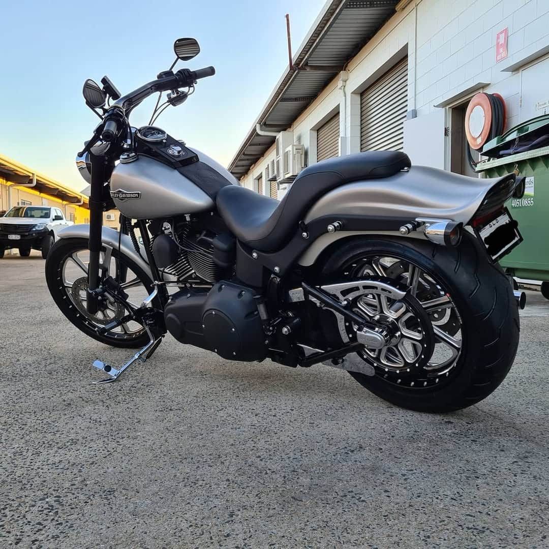 A Harley Davidson Motorcycle is Parked in Front of a Building — Straightline Detailing Cairns in Bungalow, QLD