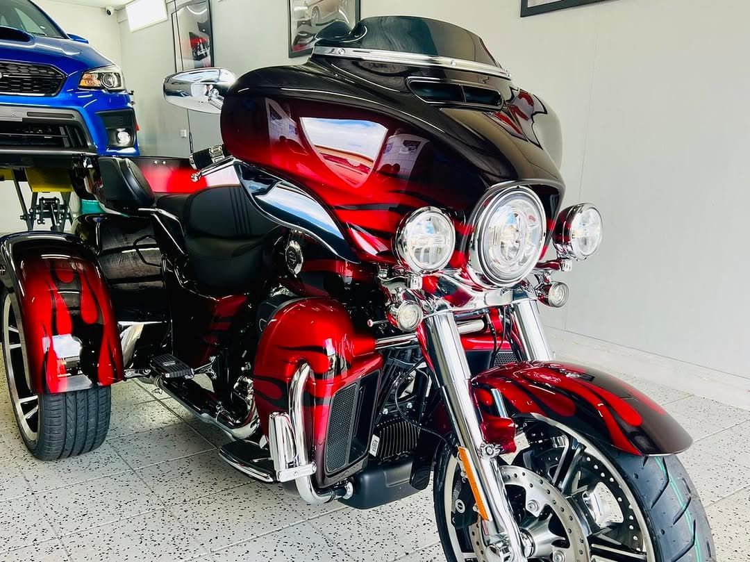 A Red Motorcycle With Three Wheels is Parked in a Garage — Straightline Detailing Cairns in Bungalow, QLD