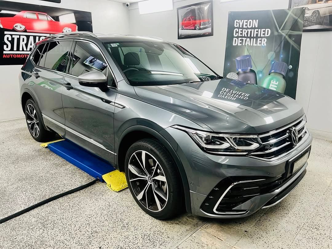 A Volkswagen Tiguan is Sitting on a Lift in a Garage — Straightline Detailing Cairns in Bungalow, QLD